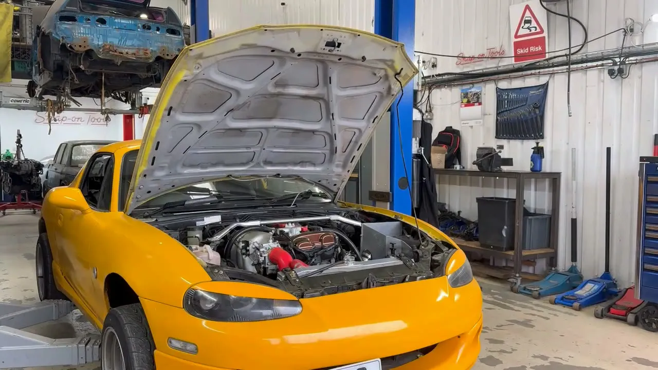 A turbo 1.8 Mk2.5 MX-5 in the workshop with the bonnet up, before the strip