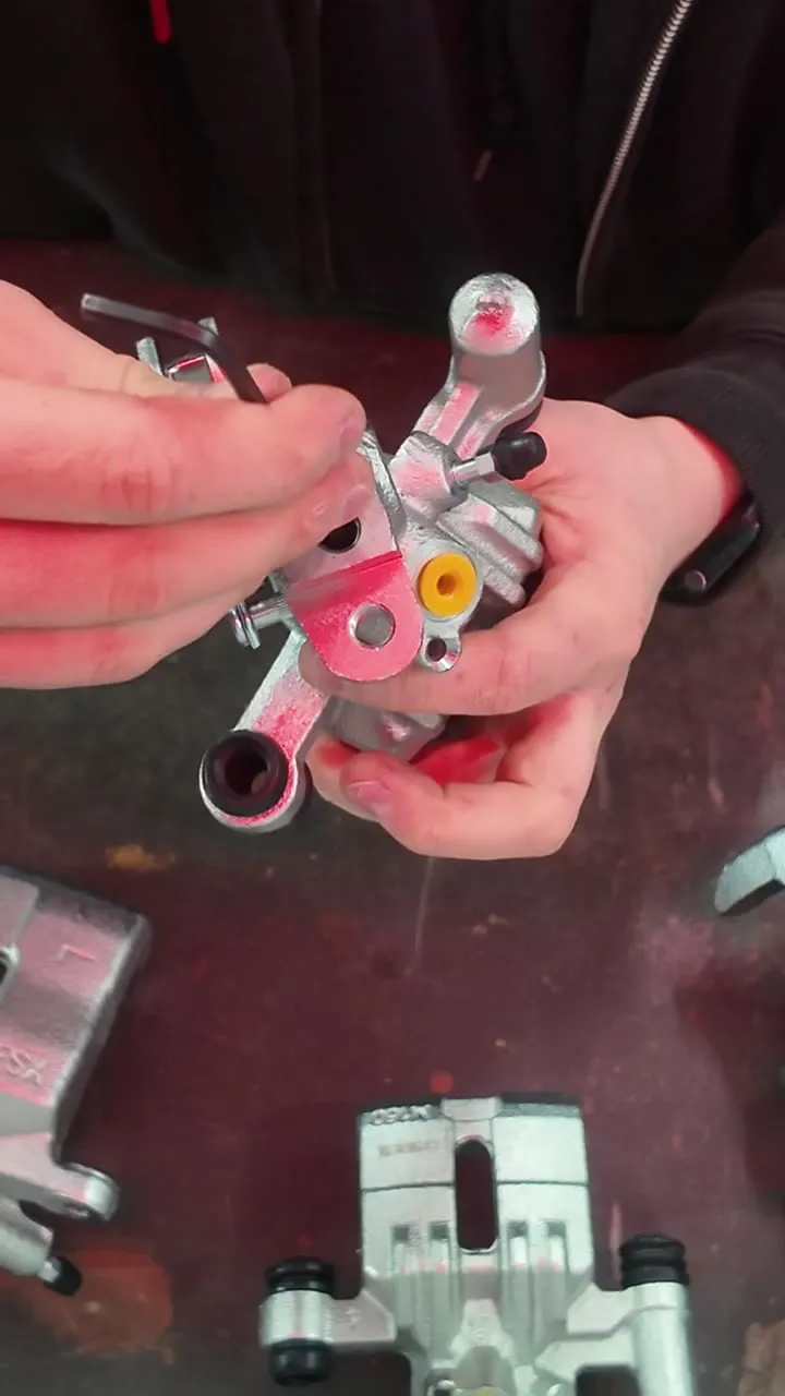 An MX-5 rear caliper showing the internal handbrake screw-adjuster mechanism