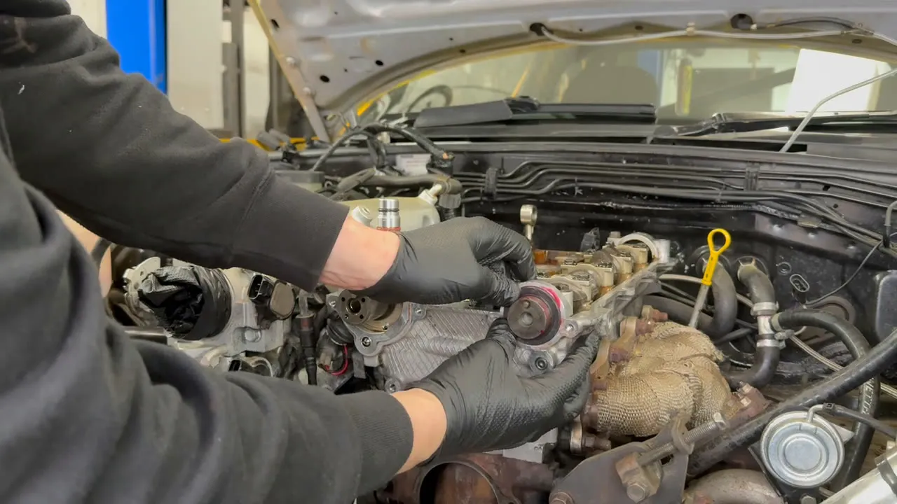 Pressing a new cam oil seal home by hand at the front of the engine