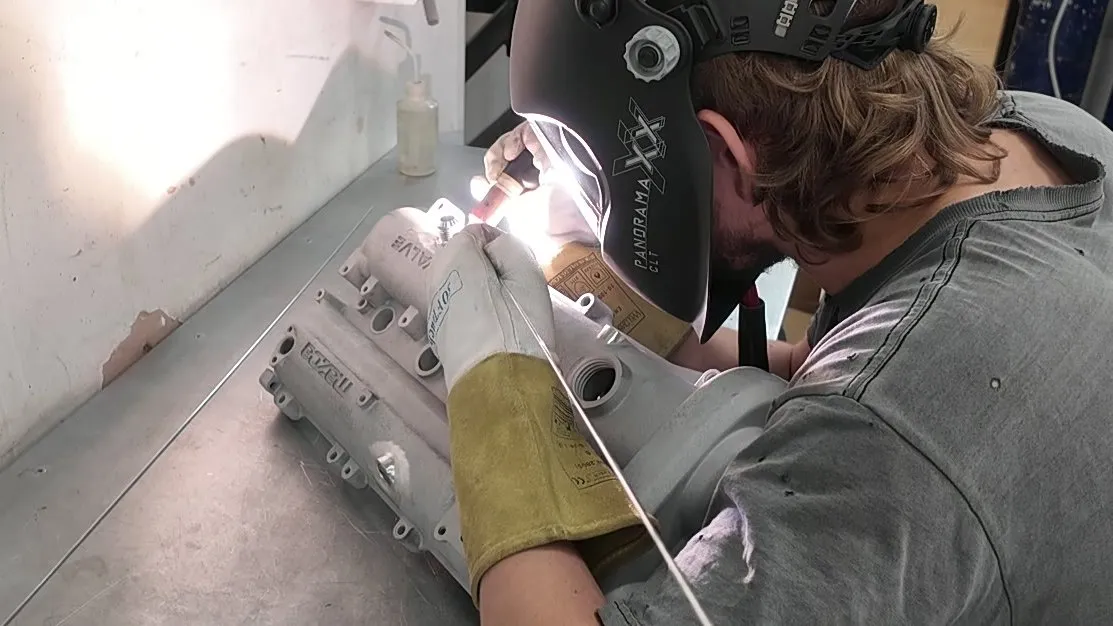 TIG welding the AN10 bungs onto the rocker cover at the bench