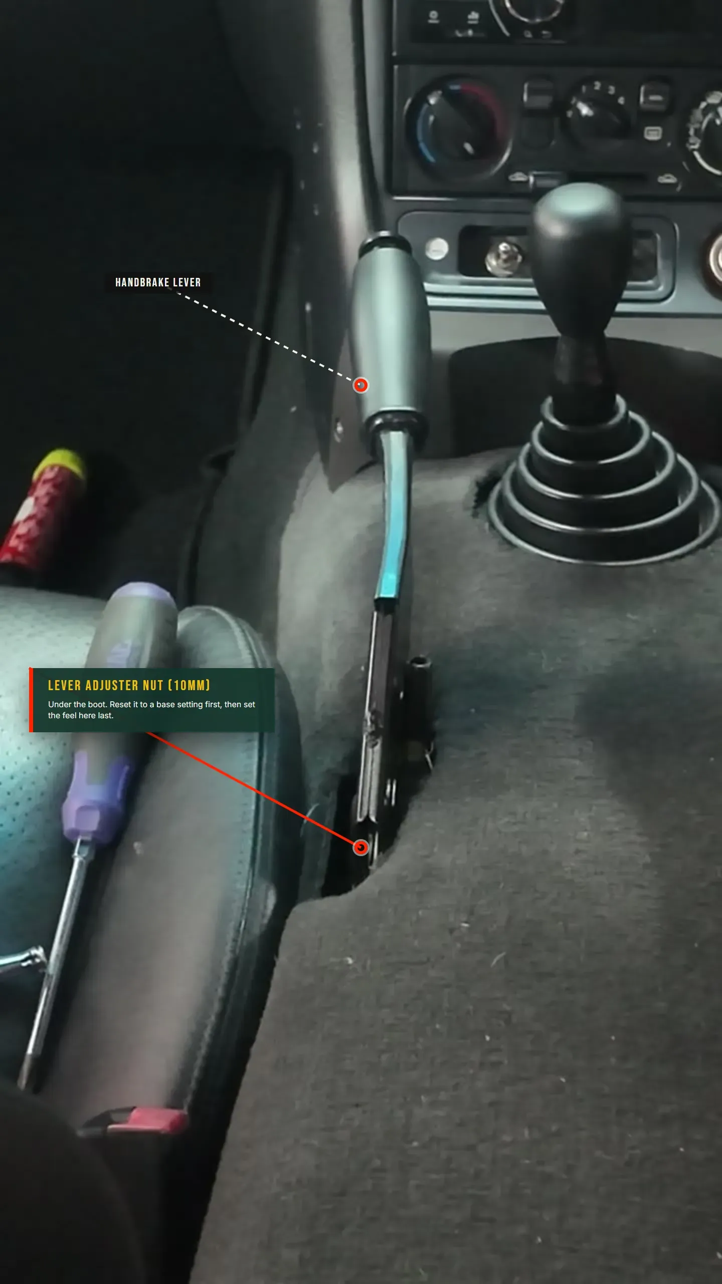 Annotated photo: the in-car MX-5 handbrake lever with the 10mm lever adjuster nut at its base under the boot