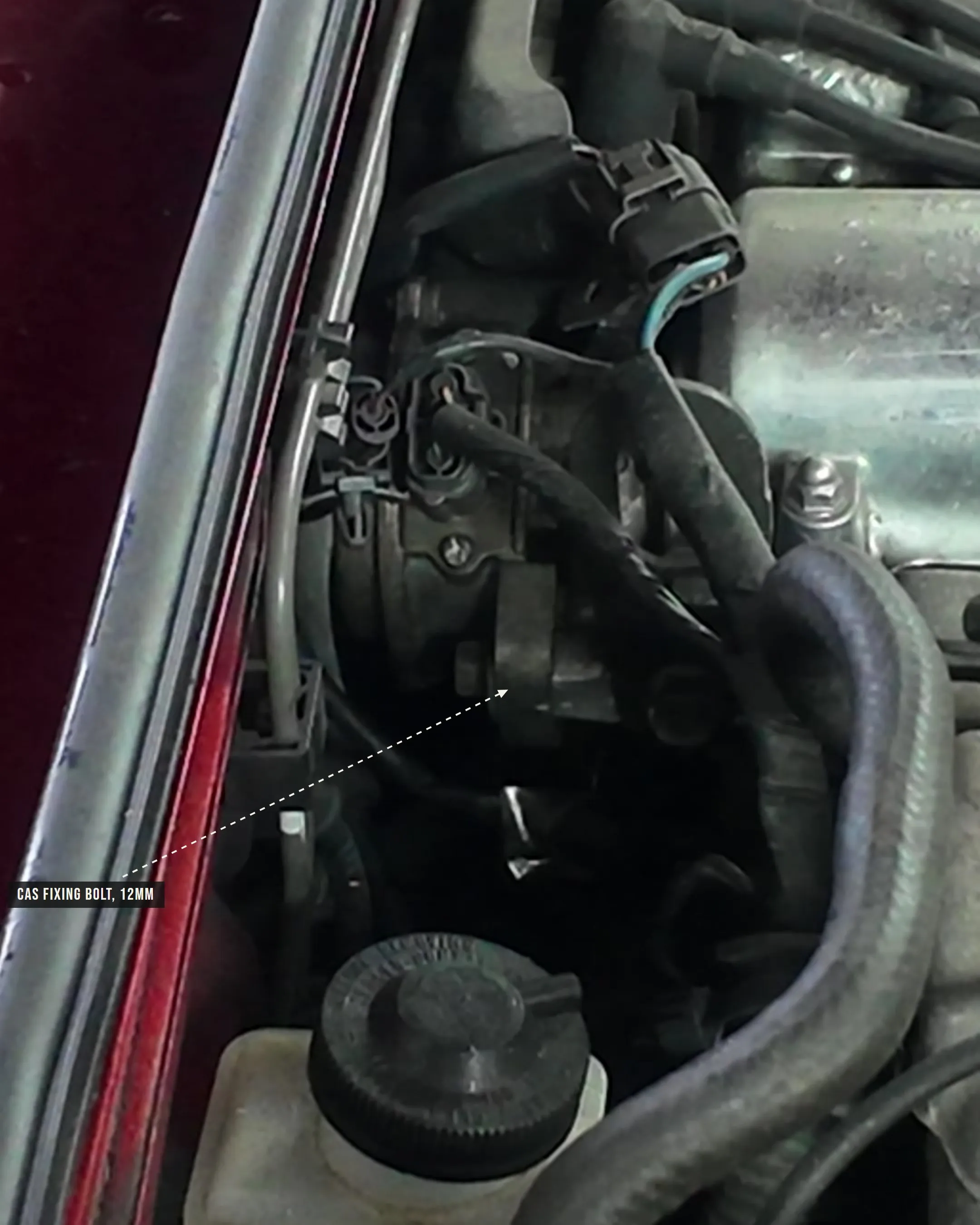 The crank angle sensor at the back of a Mazda MX-5 Mk1 cylinder head, with its 12mm fixing bolt marked