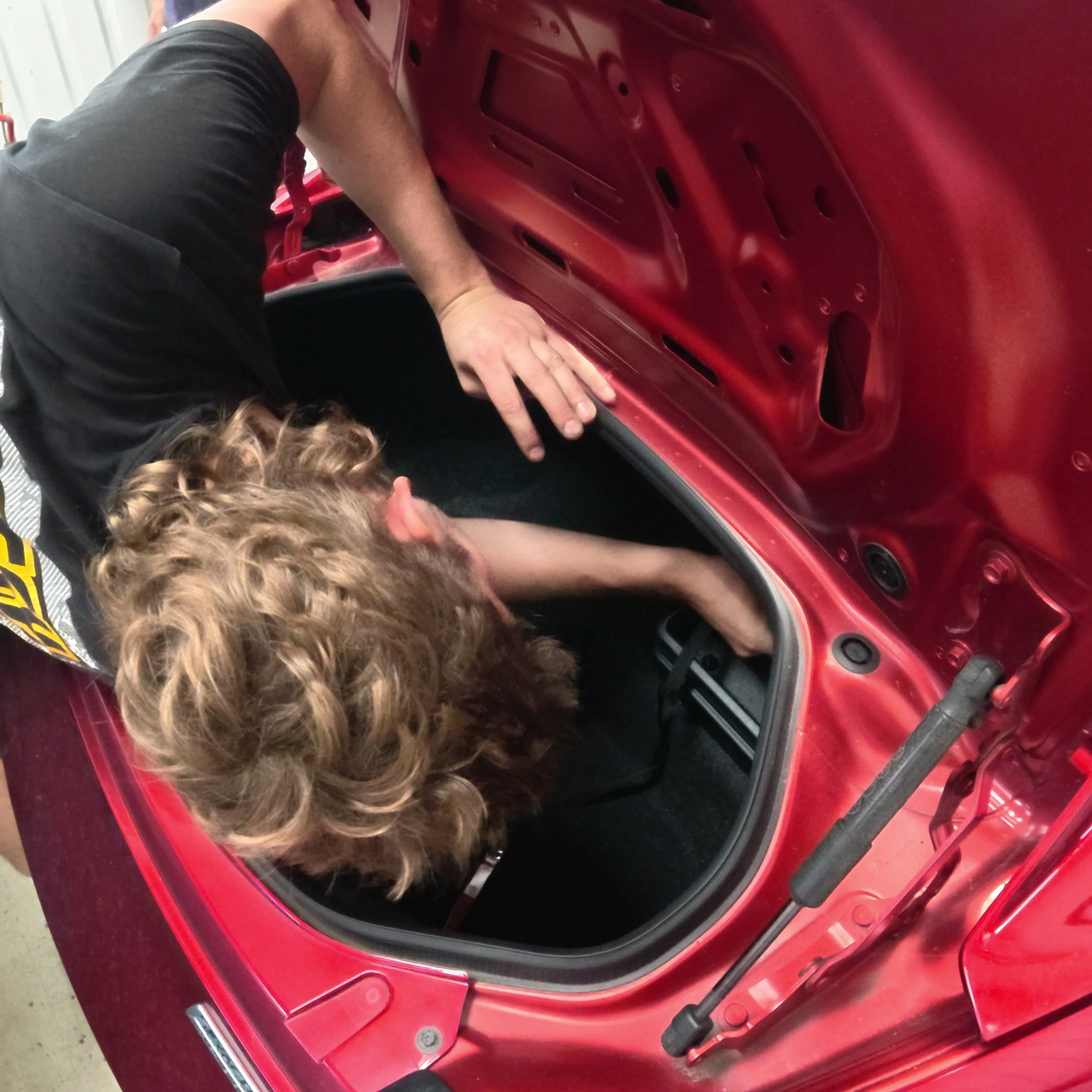 Leaning into the boot to get at the rear top mounts