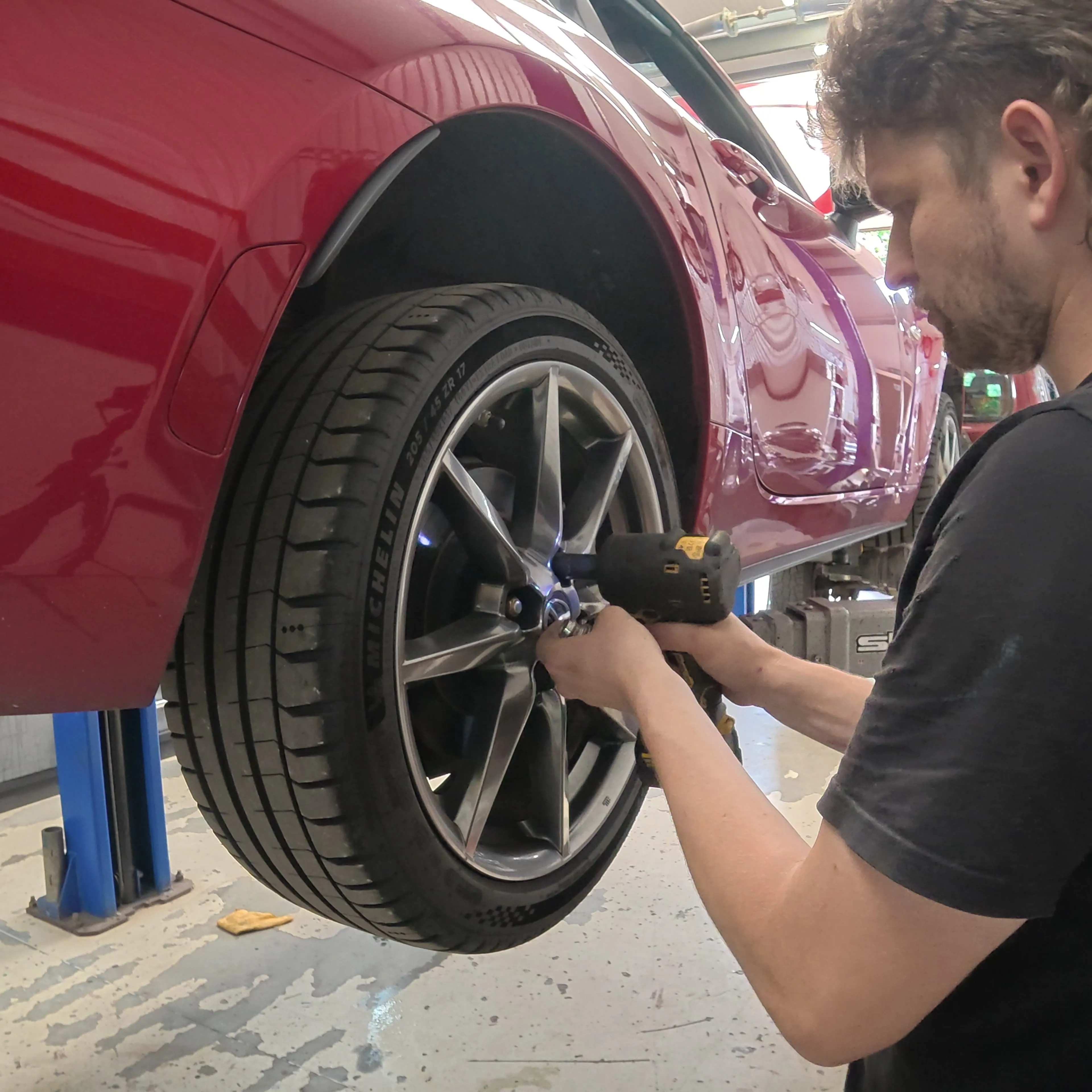Torquing the wheel back on with the car still in the air