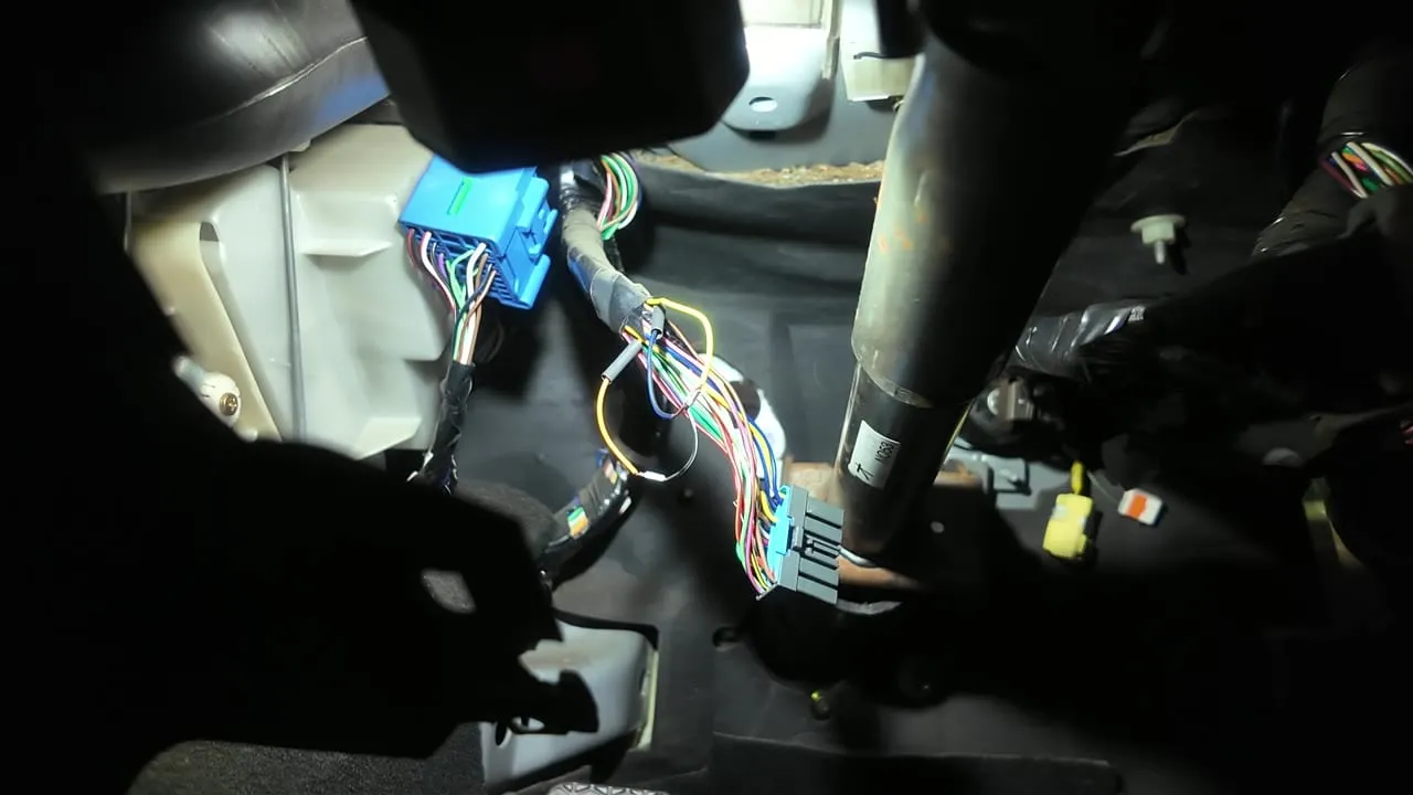 A wiring splice joined and covered with heat shrink in the footwell