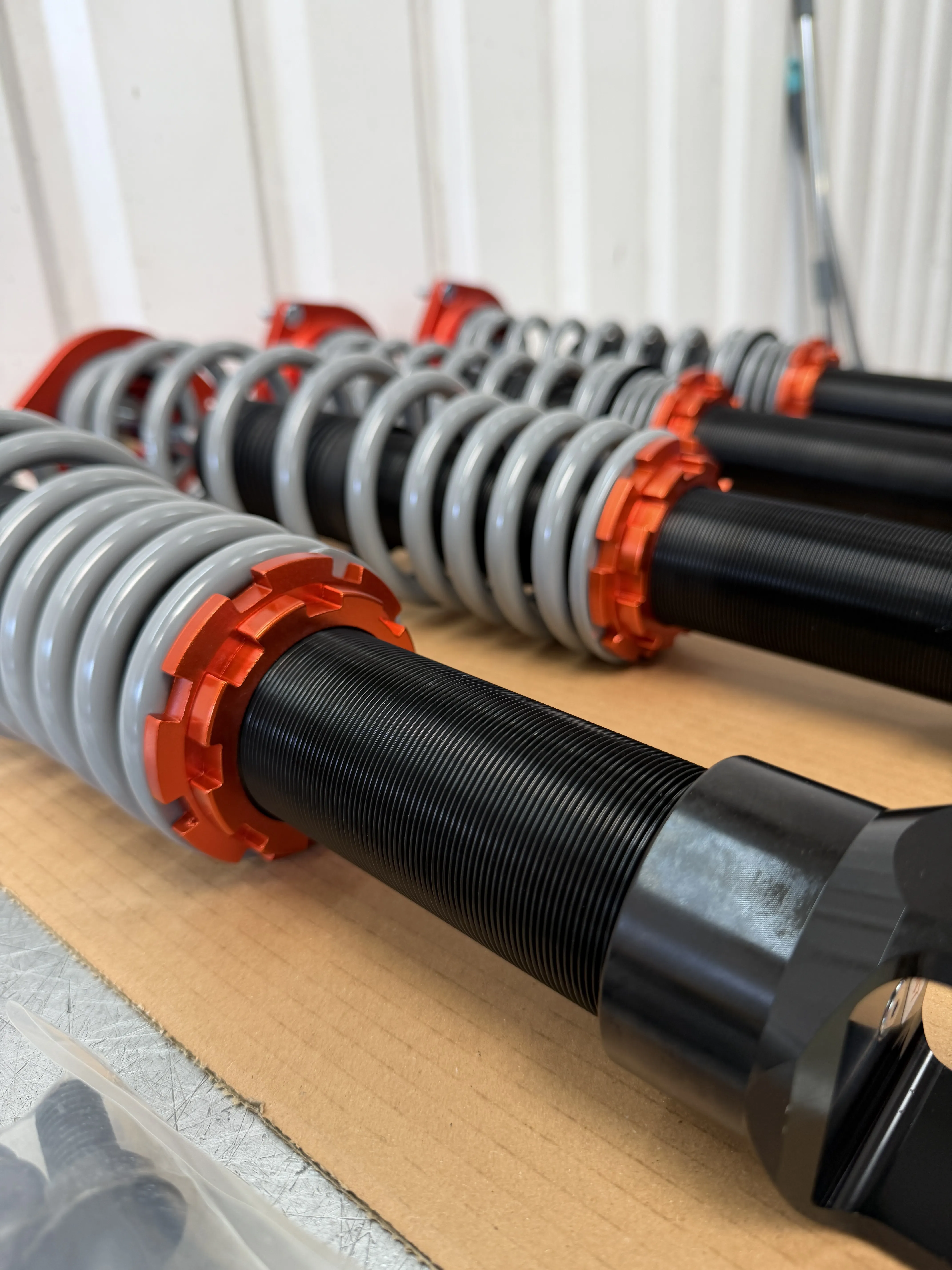 Close up of the Tecna threaded bodies, spring perches and orange lock rings on the bench