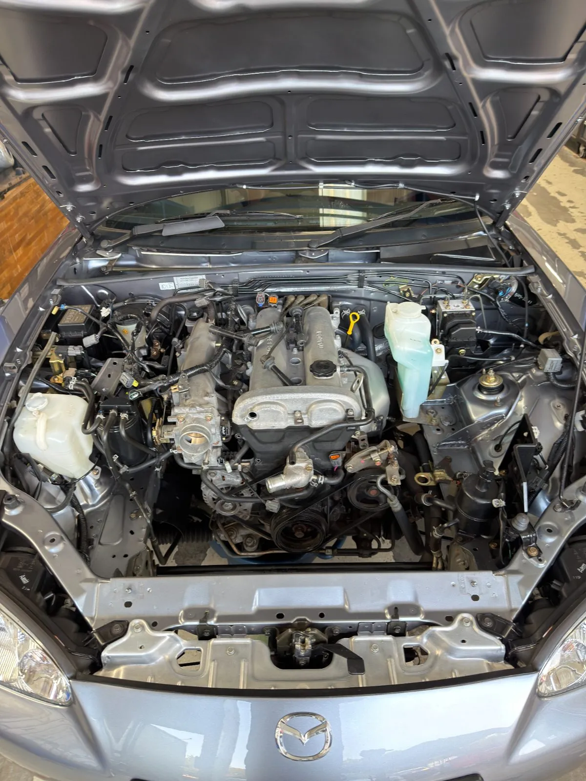 The engine bay mid-job with the front end stripped for the work