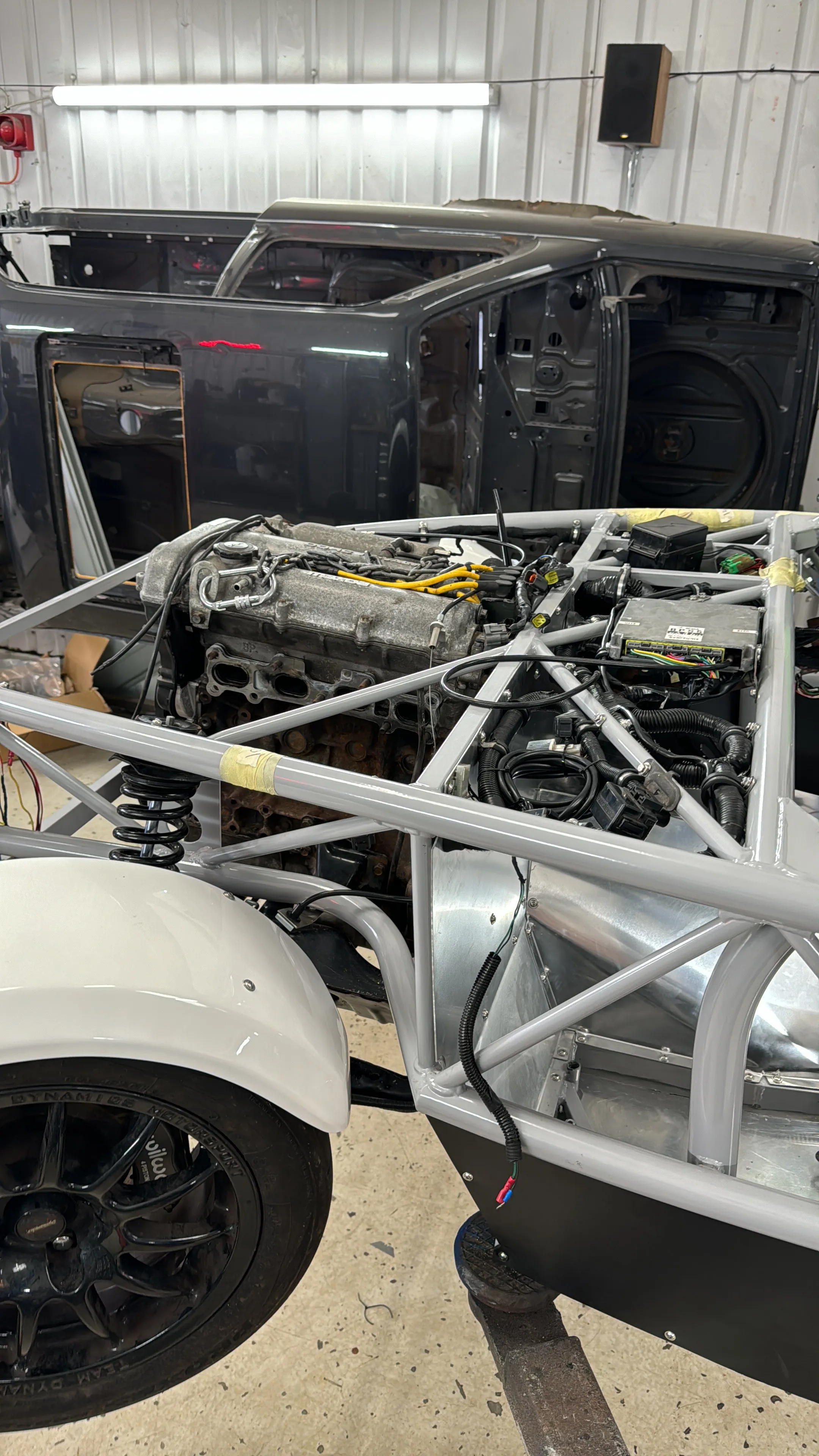 The near side front arch fitted, engine in the chassis behind it