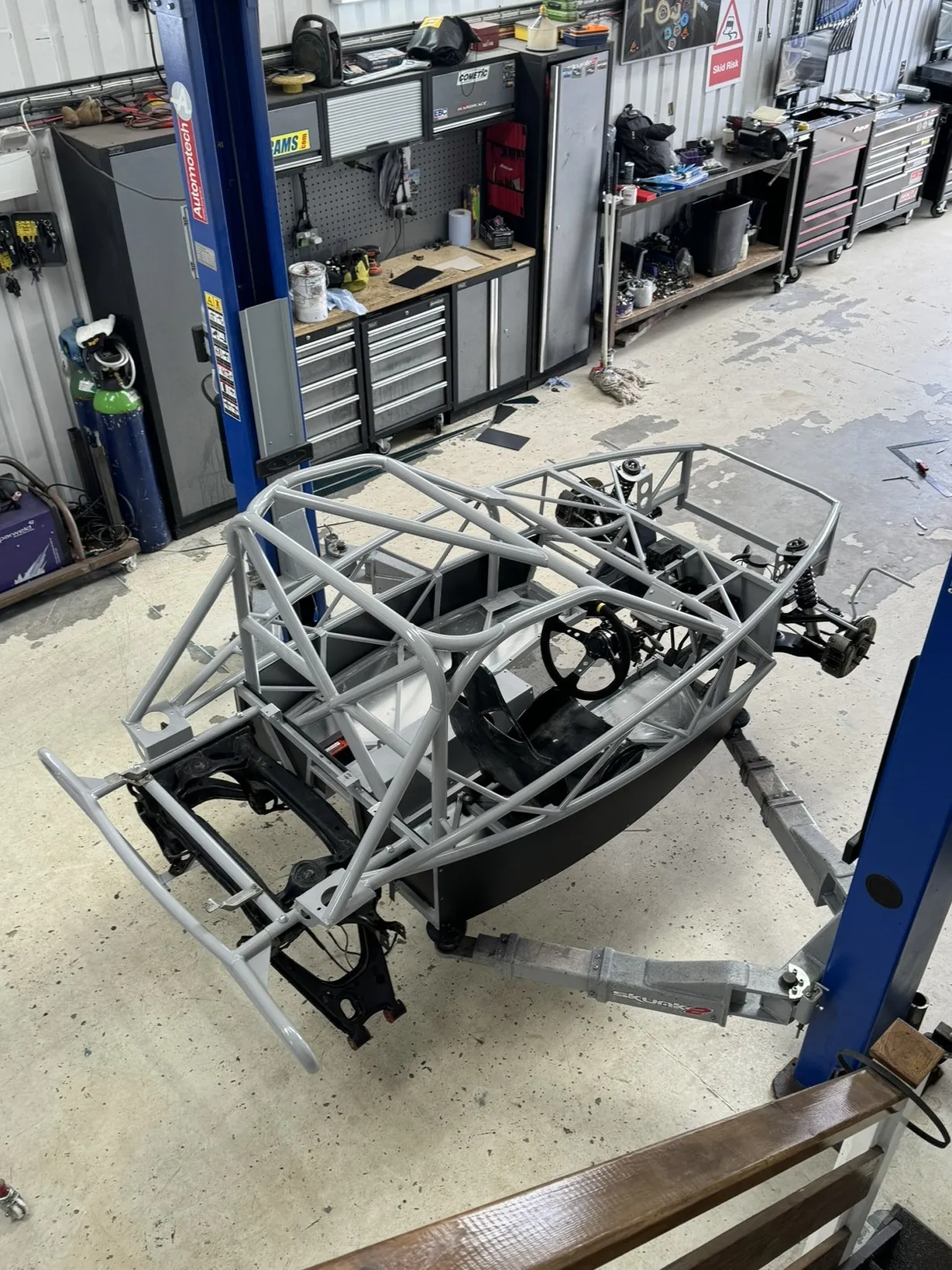 The chassis on the ramp with both subframes in and the front suspension built