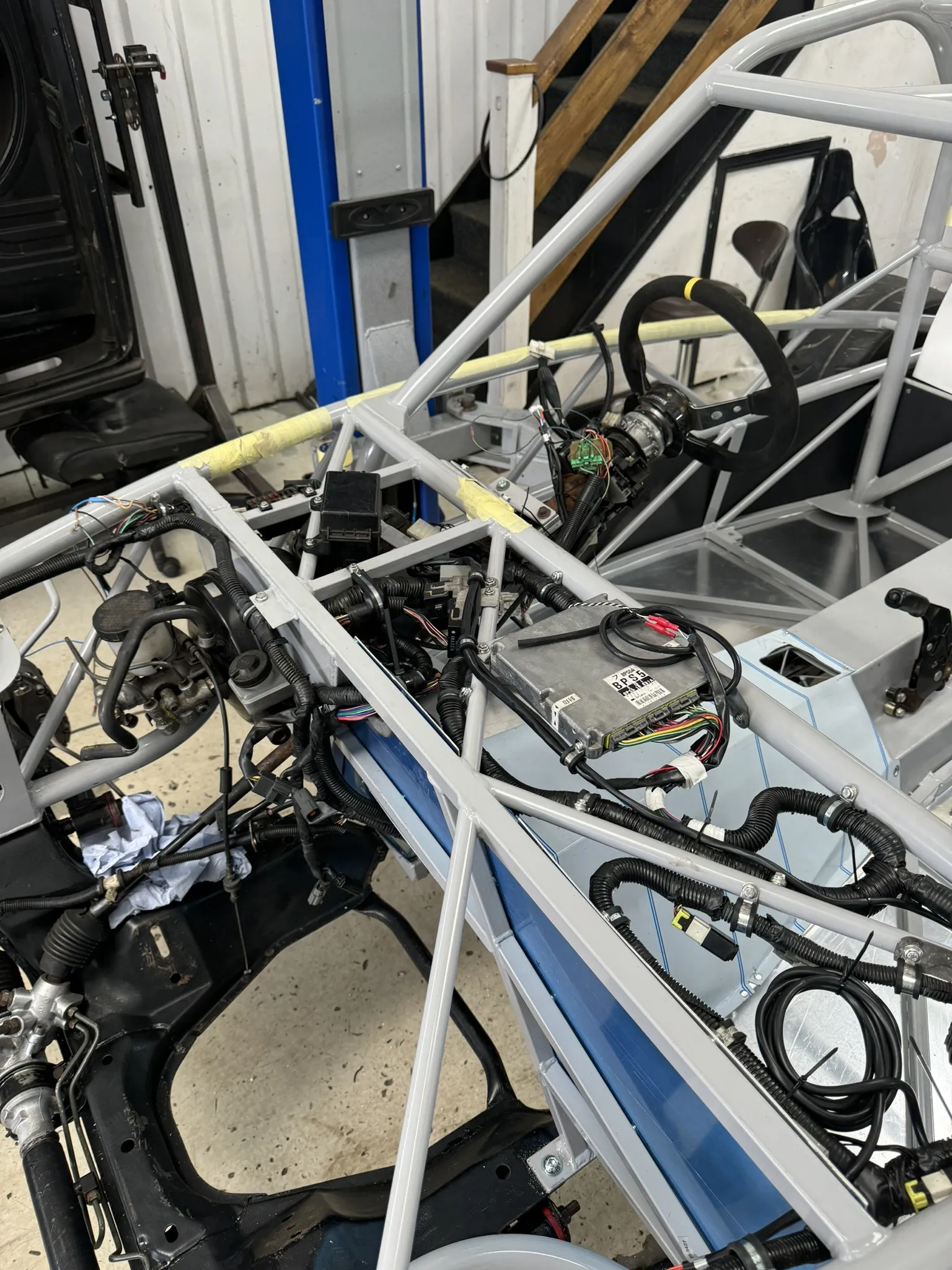 The loom laid into the chassis, the ECU sitting on the tunnel rail