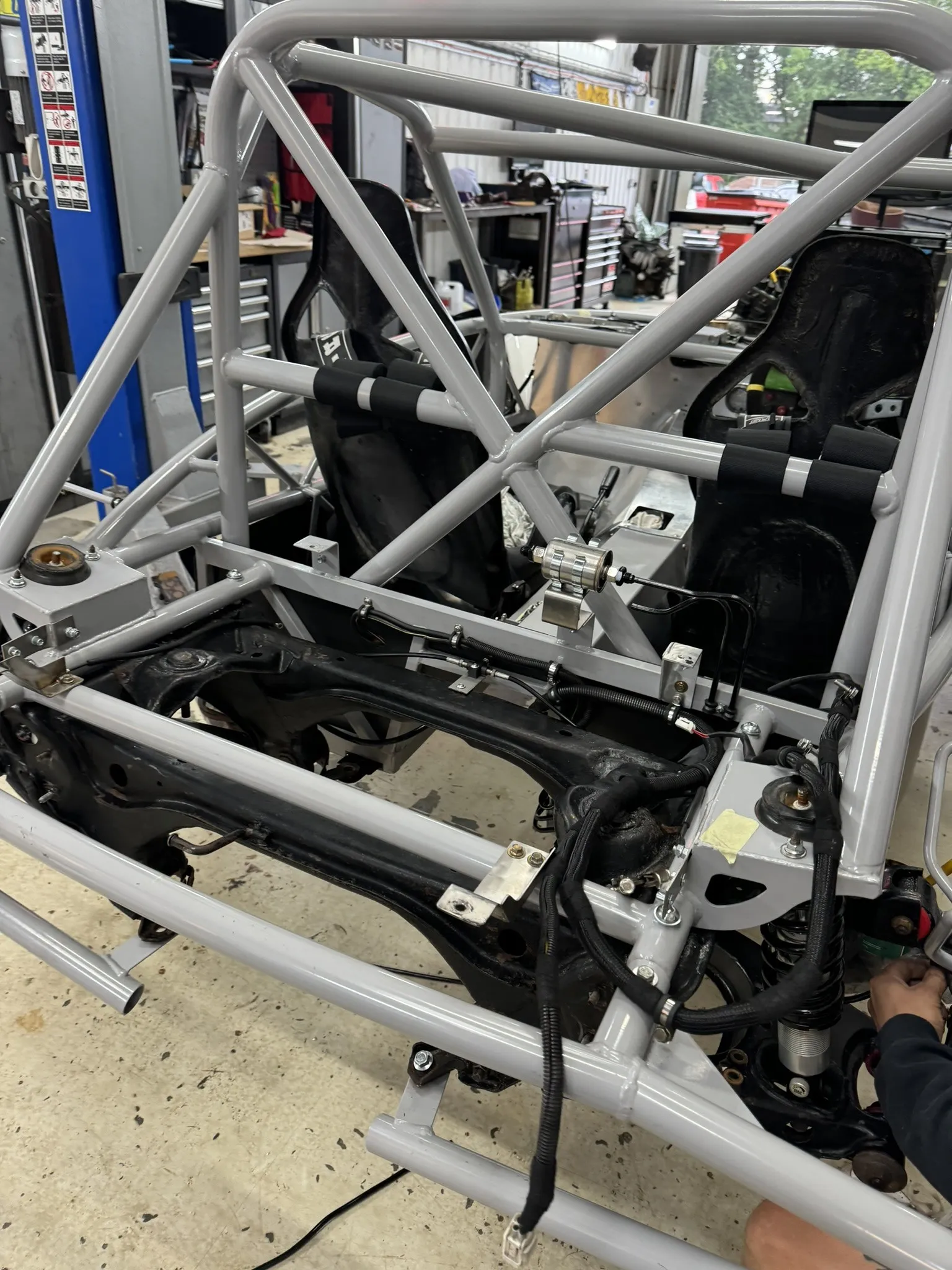 The bias valve on its made plate with the rear brake lines, rear subframe below