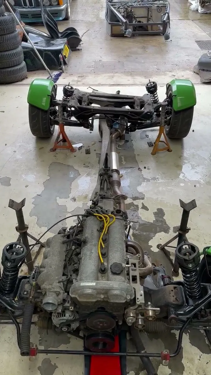 The engine, gearbox and both subframes out of the old chassis as one unit on stands