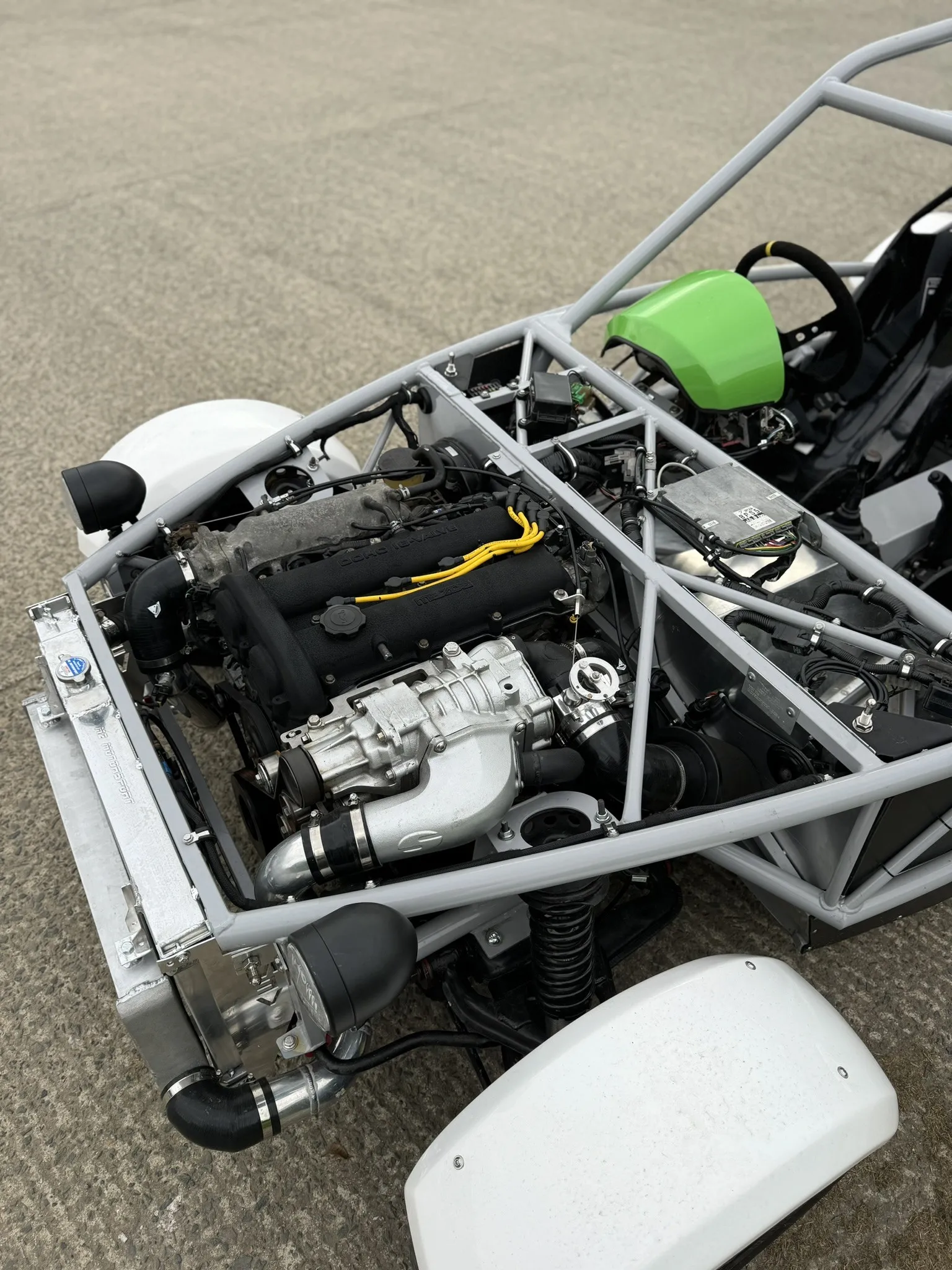 The supercharger on the inlet side of the engine, radiator and intercooler ahead of it