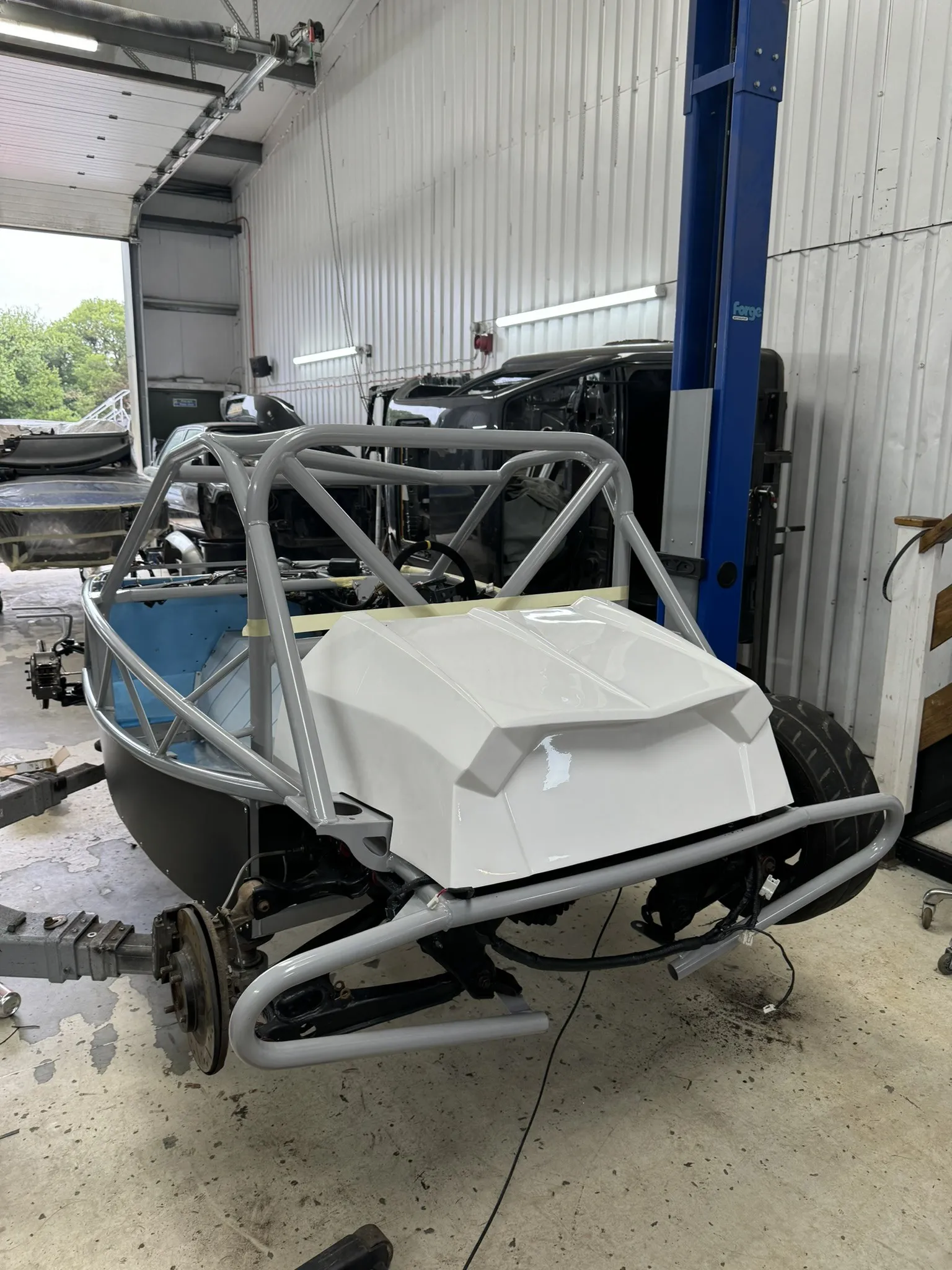 The white rear tub sitting on the chassis for its first test fit over the tank