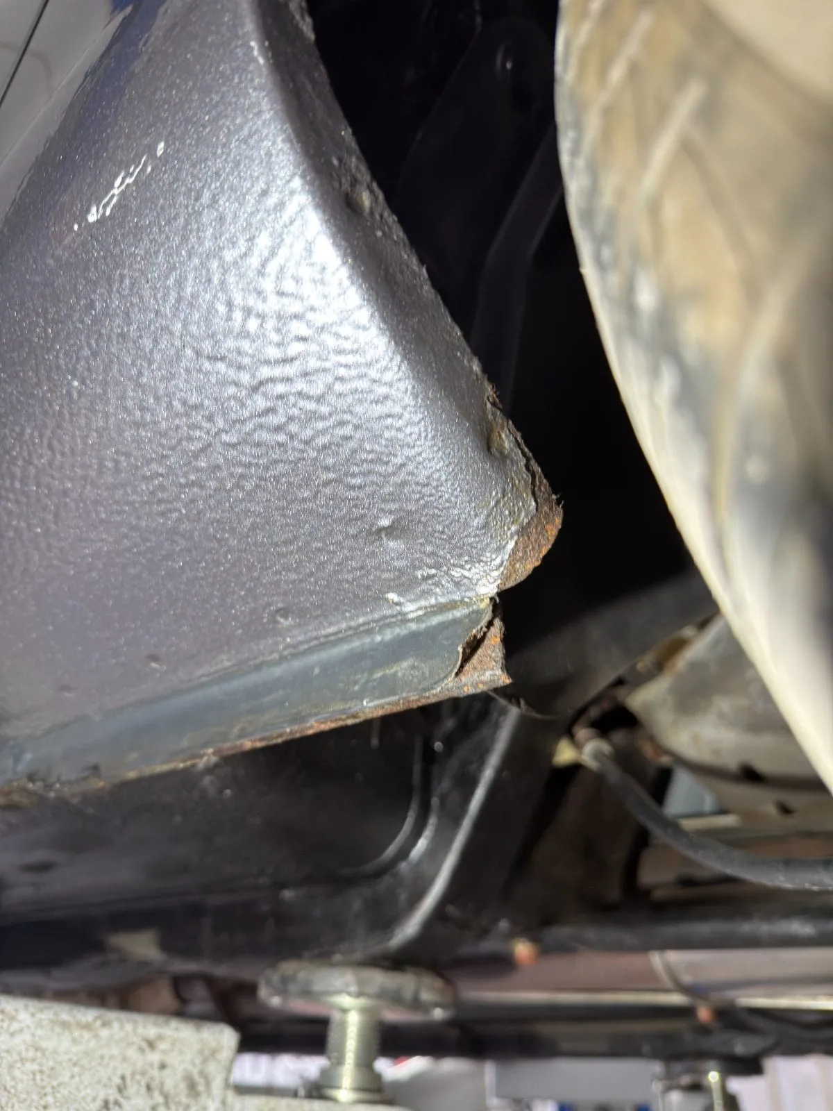 Corrosion starting at the rear sill, seen from underneath on the ramp