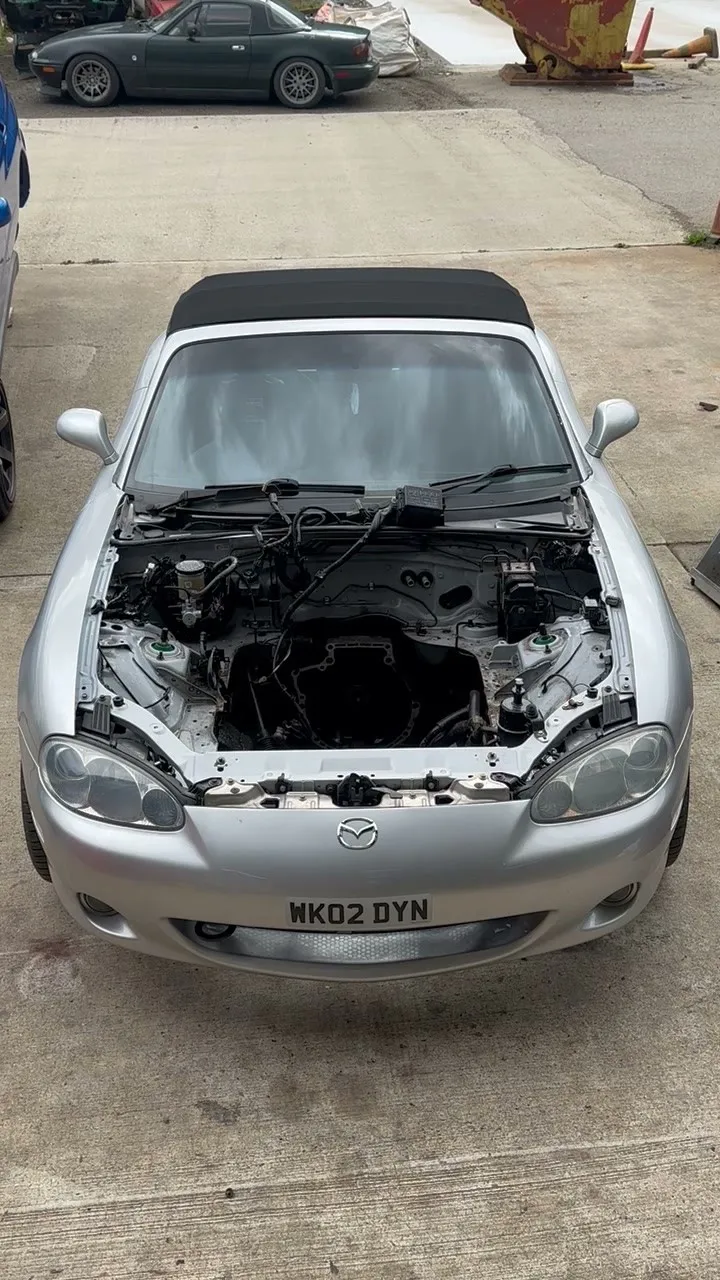 The silver Mk2.5 with the bonnet up and the engine bay completely stripped and cleaned out