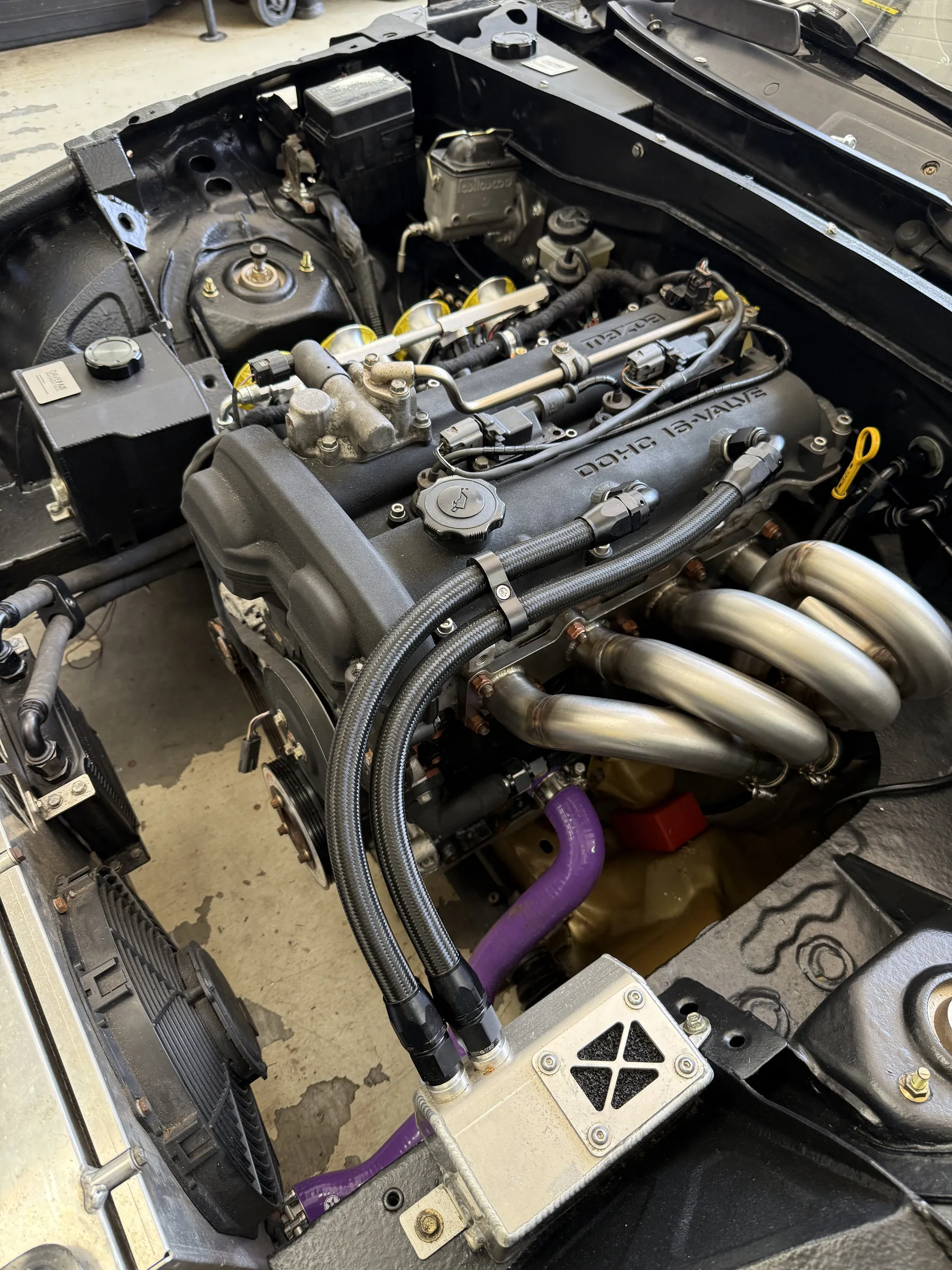 The finished bay the harness was built for, throttle bodies and manifold in place