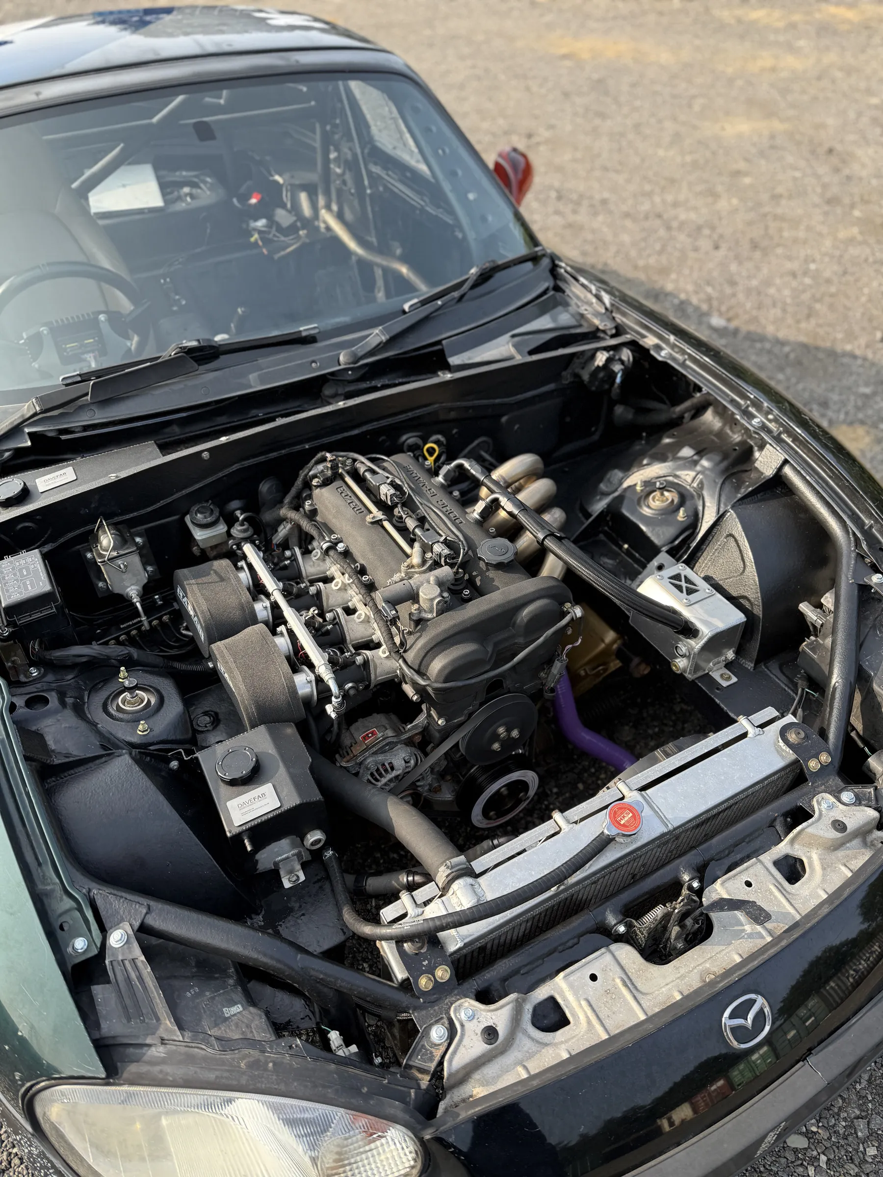 Looking down into the bay past the roll cage, throttle bodies and manifold in the car