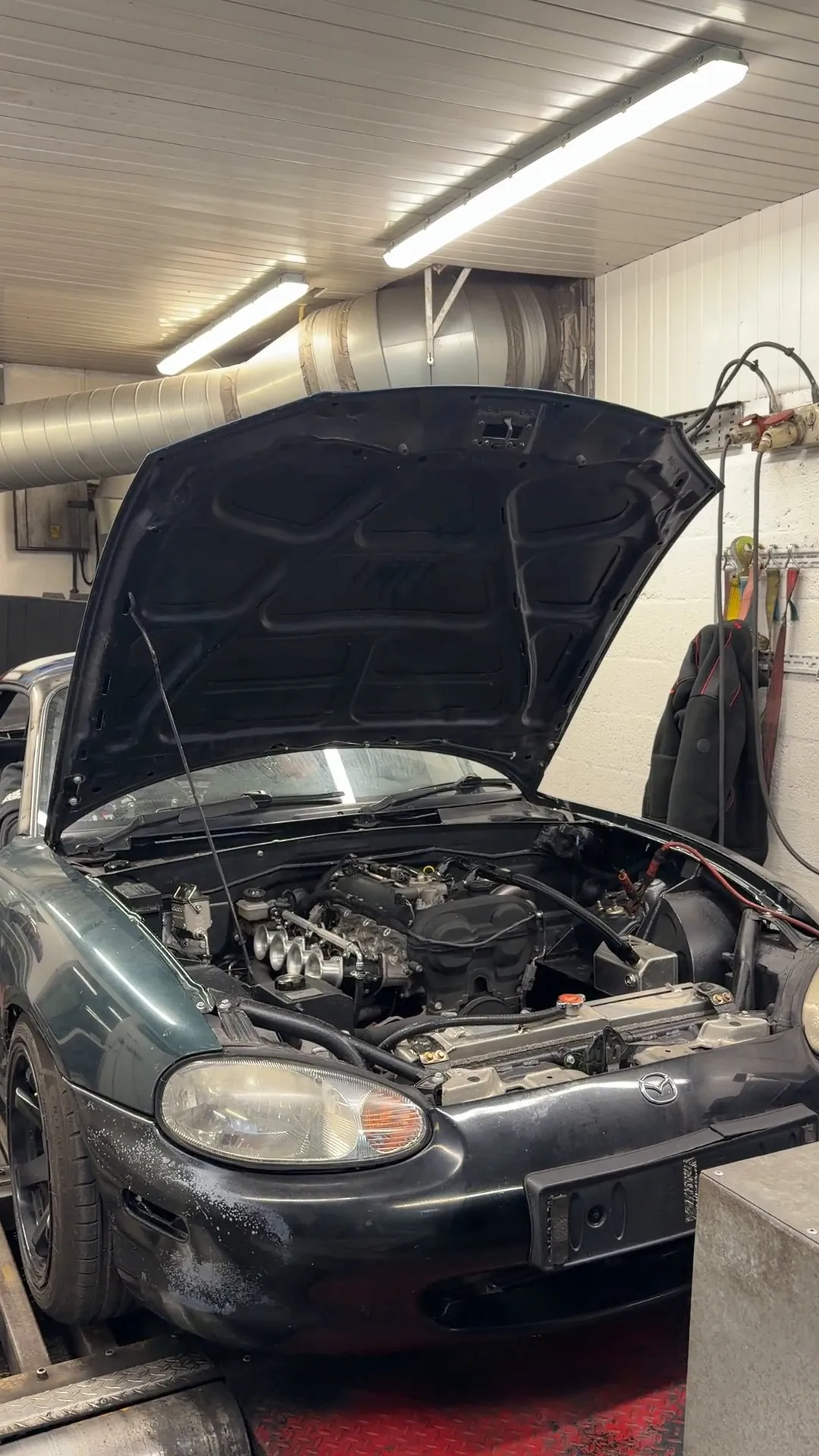 The green Mk2 strapped down on the rolling road with the bonnet up