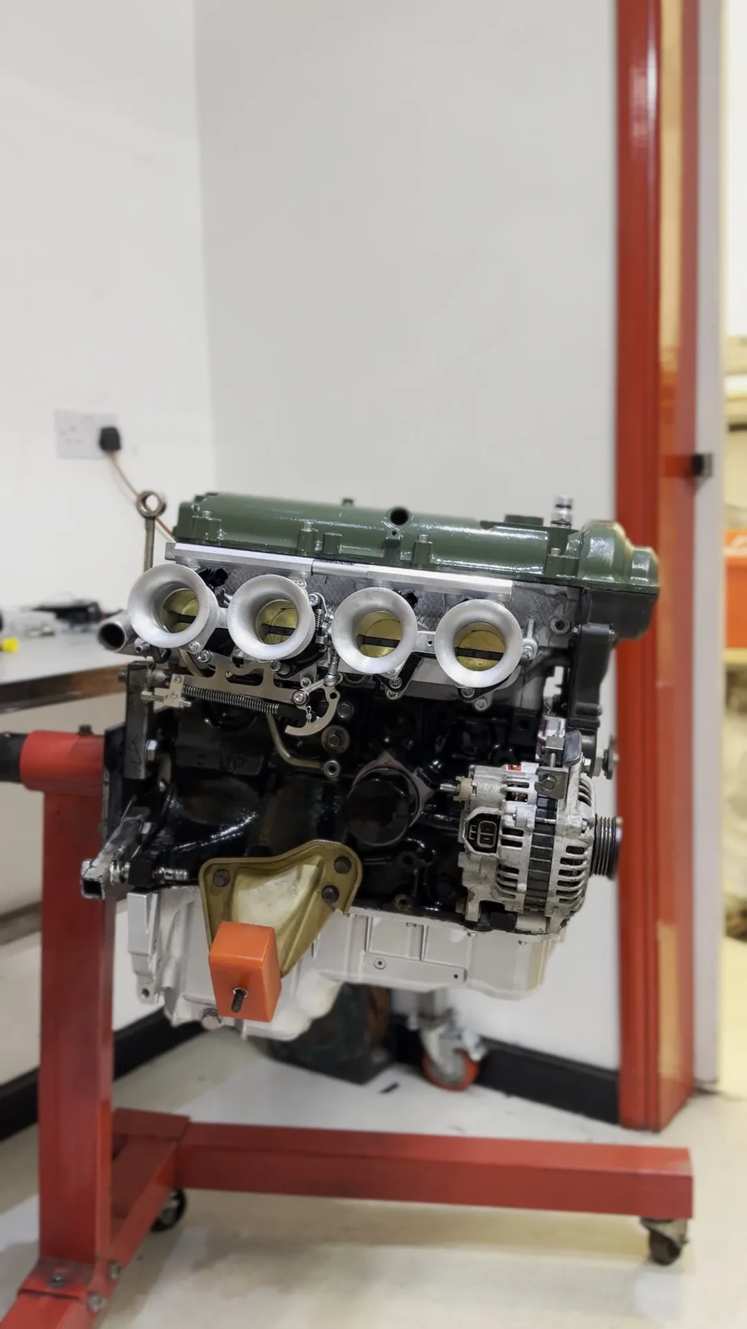 The finished engine on its stand, painted green with the bodies and trumpets on