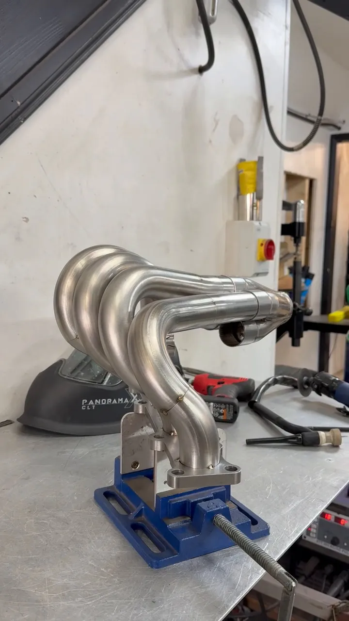 The manifold runners tacked up and held in a fixture on the bench during fabrication
