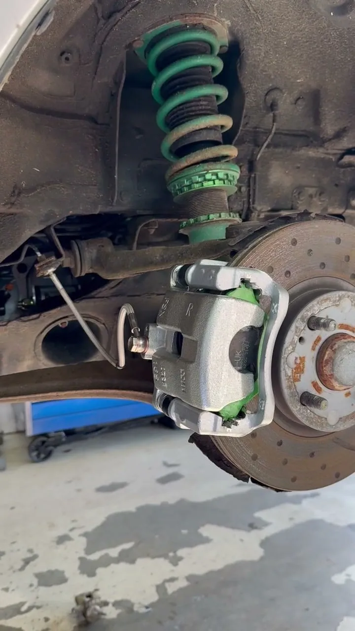 New caliper and braided line on the front, the kept cross drilled disc behind