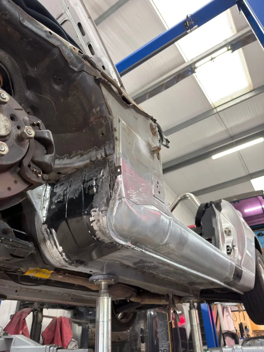 A structural weld repair on an MX-5 sill, fresh steel let into the chassis