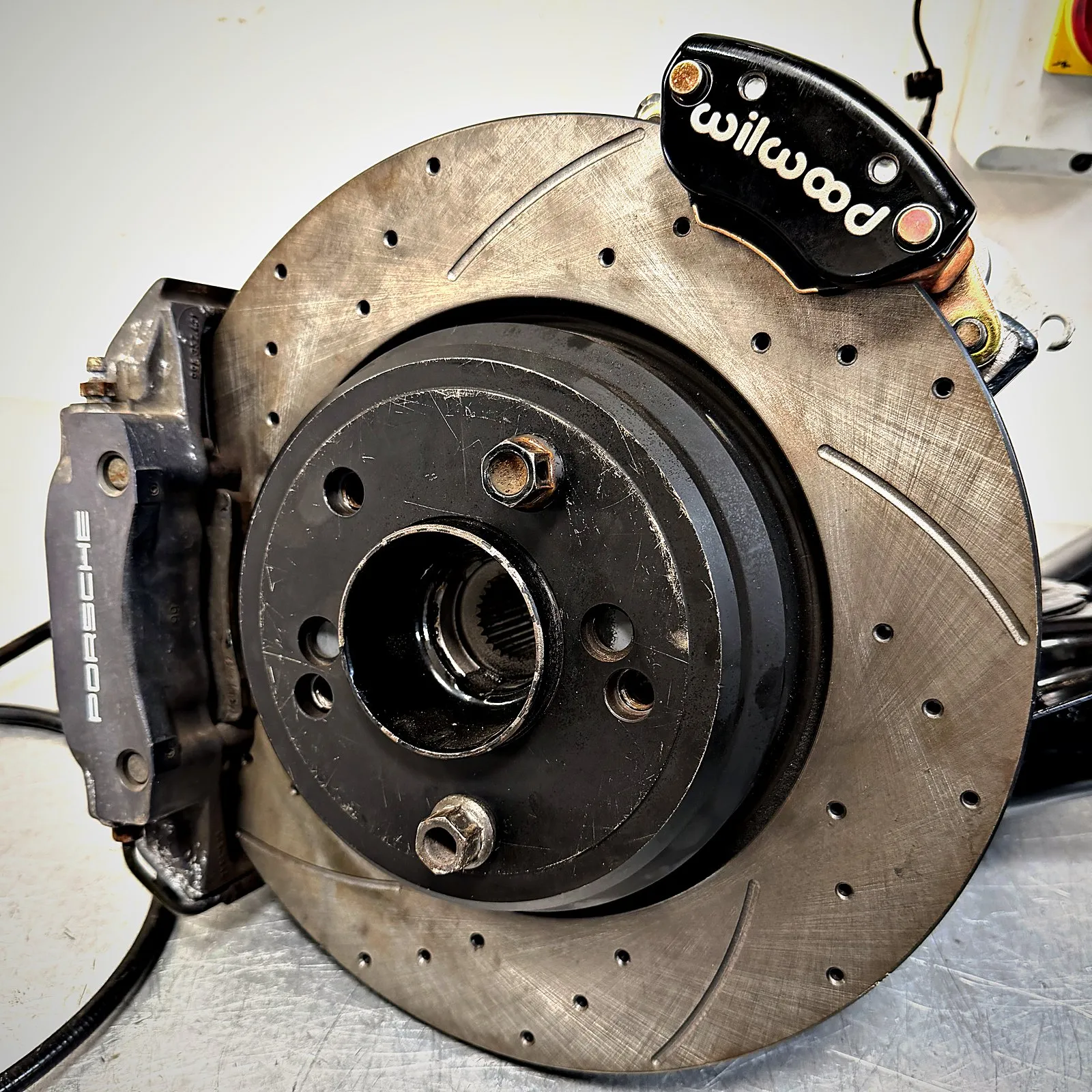 The Porsche caliper and Wilwood handbrake caliper on the disc, close up