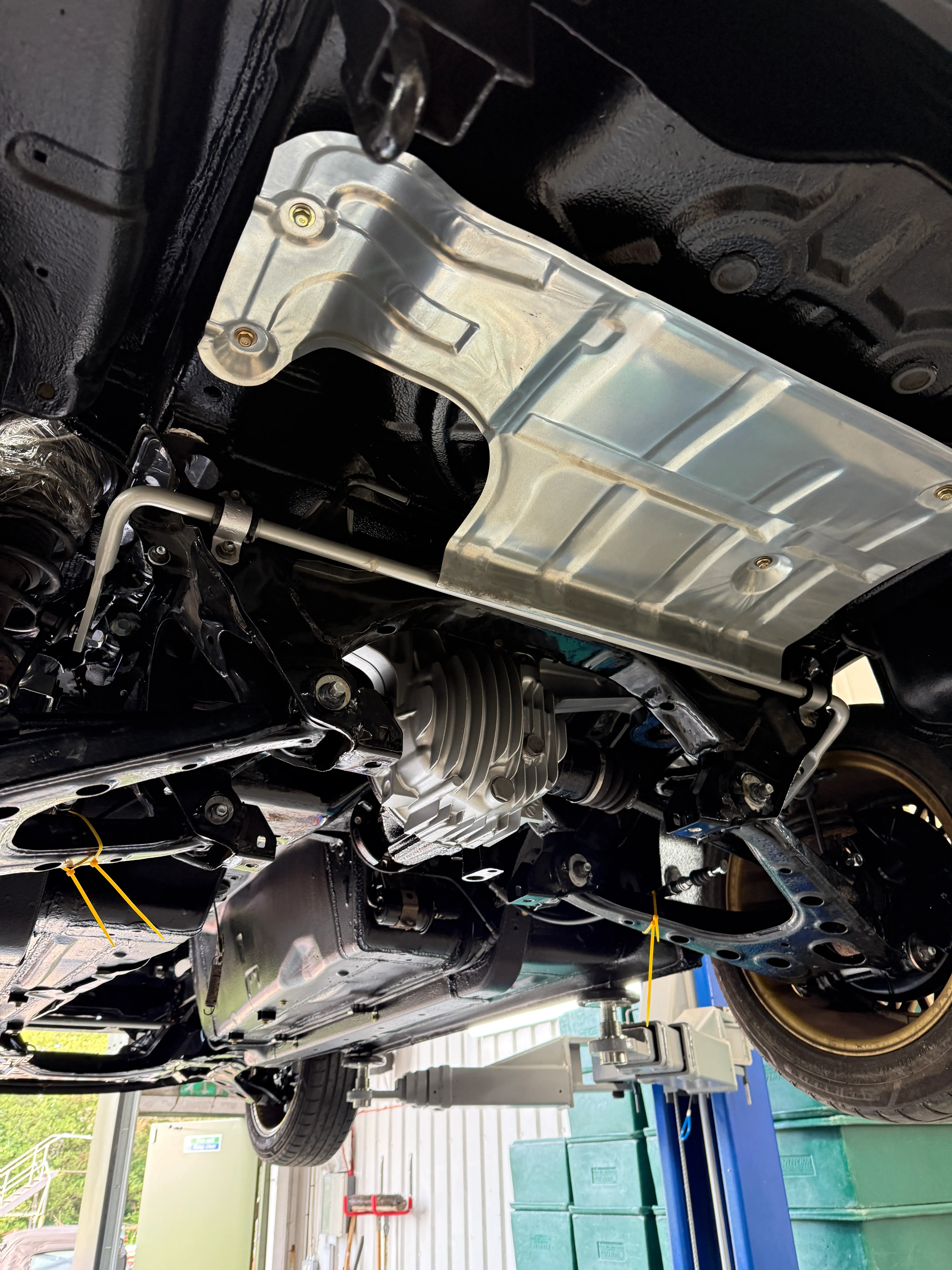 A freshly restored underbody on the lift, new heat shield, rear differential and undersealed floor