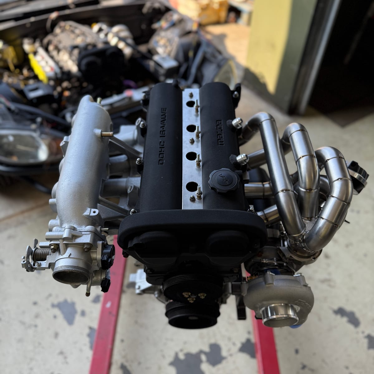 Turbocharged twin-cam engine built up on a stand